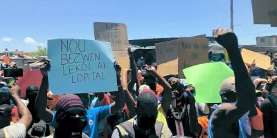 2021-07-01-A-G9-rally-in-La-Saline-blue-sign-says-we-need-schools-and-hospitals-scaled.jpg
