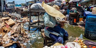 CROIX-DES-BOSSALES-in-2019-Mariette-Paul-sells-tomatoes-and-onions-amid-sewage-Photo-Marie-Michelle.jpeg