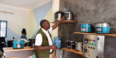 David-Ucha-showcasing-some-of-the-eco-stoves-that-Detra-Energy-and-Environmental-Contractors-offers.jpeg