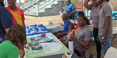 Employees-in-the-Division-of-Youth-sharing-a-light-moment-at-the-ministrys-community-outreach-progra.jpeg