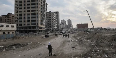 Getty-Images-Displaced-Palestinians-pass-destroyed-buildings-as-they-return-to-the-north-from-the-southern-Gaza-Strip-on-Tuesday.-.webp.webp