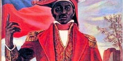 Jean-Jacques-Dessalines-waist-up-portrait-with-flag.jpg