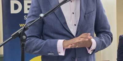 Minister-speaks-scaled.jpg