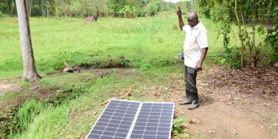 Ogwal-showcasing-his-solar-panel-that-powers-irrigation-on-his-farm-acquired-from-Tulima-Solar-a-par.jpeg