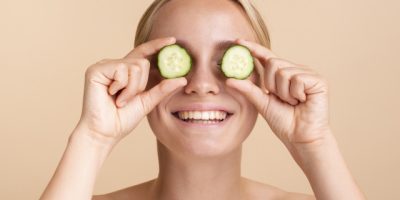close-up-happy-woman-with-cucumber-slices.jpg