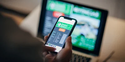 man-using-mobile-app-for-live-betting-and-online-gambling-and-watching-a-sports-match.webp.webp
